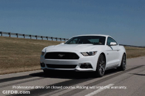 A White Mustang Is Driving Down A Road With The Words Professional Driver On Closed Course Racing Will Void The Warranty GIF