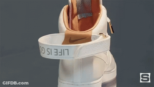 A White Nike Shoe With The Word Life Is On The Strap GIF