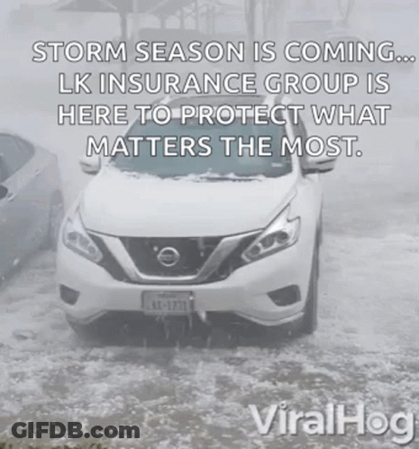 A White Nissan Car Is Driving Through A Snowy Road . GIF