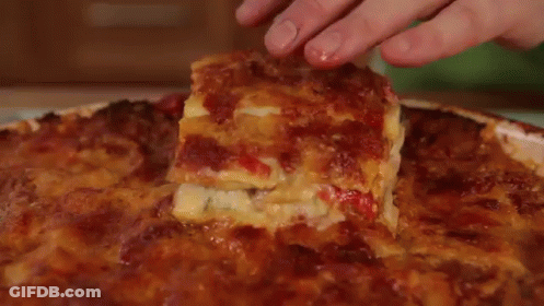 A White Plate Topped With A Slice Of Lasagna . GIF