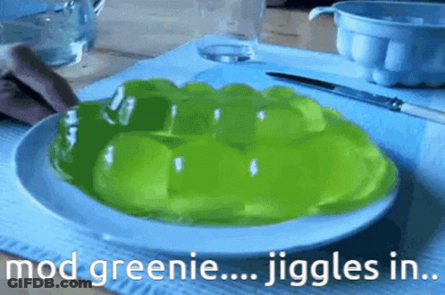 A White Plate Topped With Green Jelly With The Words Mod Greenie Jiggles In GIF
