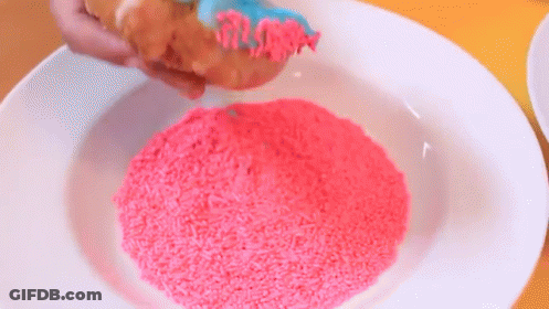 A White Plate Topped With Pink Sprinkles And A Piece Of Bread . GIF