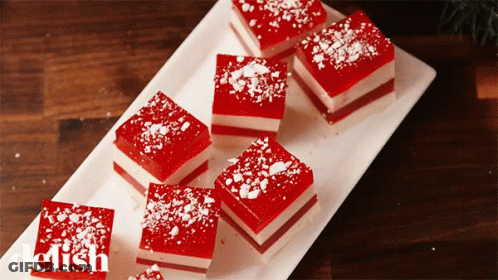 A White Plate Topped With Red And White Squares With The Word Delish On The Bottom Right GIF