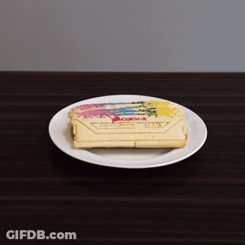 A White Plate With A Piece Of Cake On It With The Word Corsair On It GIF