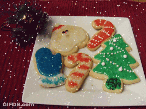 A White Plate With Christmas Cookies On It GIF
