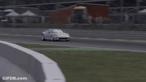 A White Porsche Is Driving Down A Track GIF