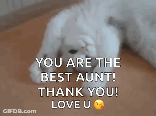 A White Puppy Is Laying On The Floor With Its Paws On Its Face . GIF