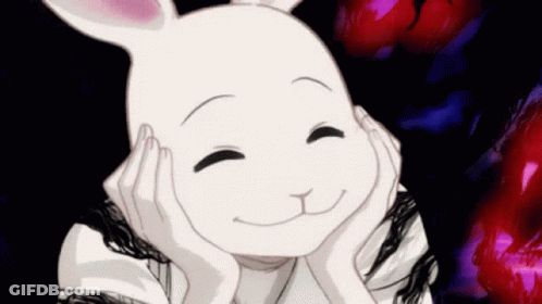 A White Rabbit Is Smiling And Holding Its Head With Its Hands . GIF