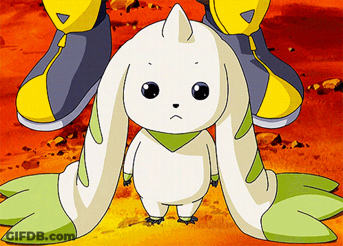 A White Rabbit With Green Ears Is Standing Next To A Person GIF