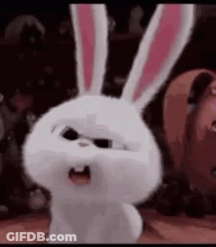 A White Rabbit With Pink Ears Is Standing In A Room With Other Animals . GIF