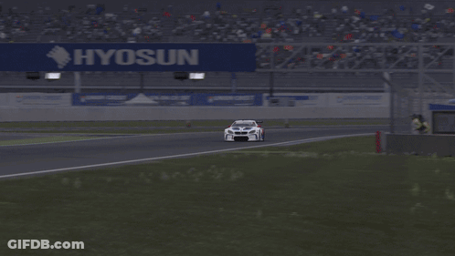A White Race Car Is Driving Down A Track With The Word Motul On The Side GIF