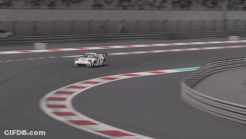 A White Race Car With The Number 14 On The Side Is Driving On A Track GIF