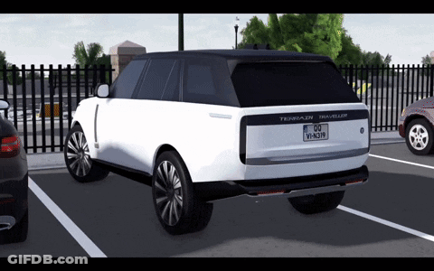 A White Range Rover Traveller Is Parked In A Parking Lot With Other Cars GIF