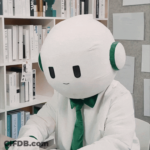 A White Robot With A Green Tie And Headphones Is Sitting In Front Of A Bookshelf With A Book Titled " You The Me " GIF