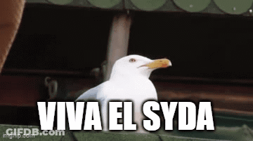 A White Seagull Is Sitting On A Green Roof With The Words Viva El Syda Written Below It . GIF