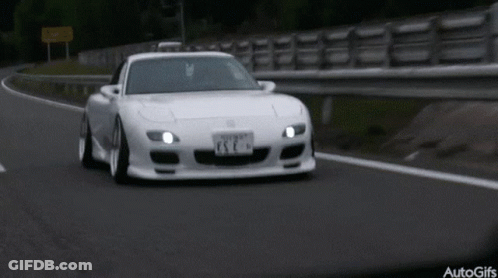 A White Sports Car Is Driving Down A Road With A License Plate That Says Esc GIF