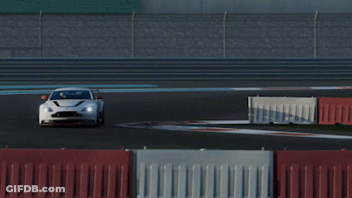 A White Sports Car Is Driving On A Race Track With Other Cars GIF
