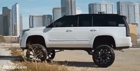 A White Suv With Black Wheels And A Sticker That Says ' Texas ' On It GIF
