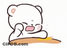 A White Teddy Bear Is Sitting At A Table With Its Mouth Open . GIF