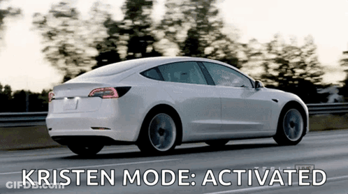 A White Tesla Model 3 Is Driving Down A Highway With Kristen Mode Activated GIF
