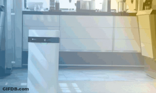 A White Trash Can In A Kitchen With The Letter G On The Top GIF