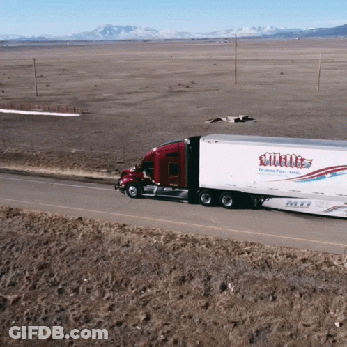 A White Truck Is Driving Down A Desert Road GIF