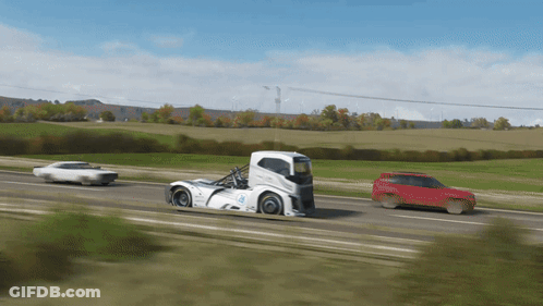 A White Truck With The Word Volvo On The Side Is Driving Down The Road GIF
