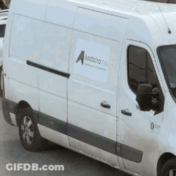A White Van Is Parked On The Side Of The Road And Has A Sticker On The Side That Says A. GIF