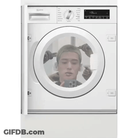 A White Washing Machine Has A Picture Of A Man 'S Head In It GIF