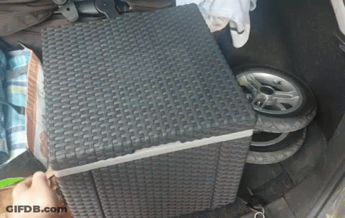 A Wicker Ottoman Sits In The Back Of A Car GIF