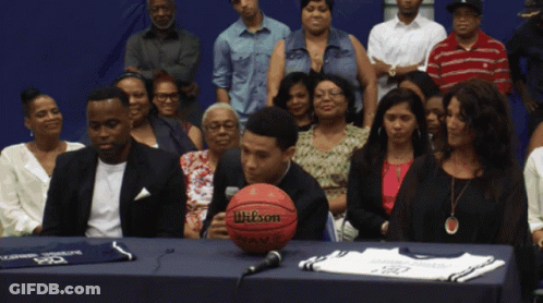 A Wilson Basketball Sits On A Table In Front Of A Crowd GIF