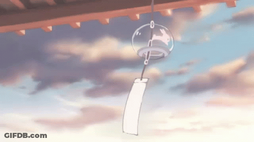 A Wind Chime With A Rabbit On It Is Hanging From The Roof Of A Building GIF