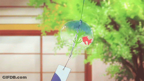A Wind Chime With A Red Fish In It Is Hanging From A String GIF