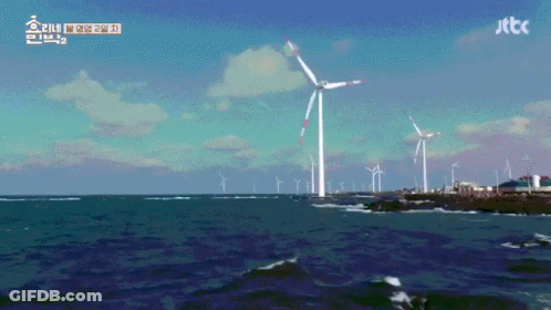 A Windmill In The Middle Of A Body Of Water With Jttc Written On The Bottom Right GIF