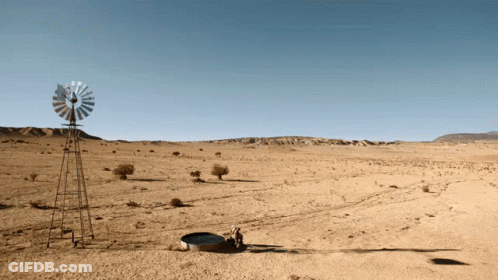 A Windmill In The Middle Of A Dry Desert GIF