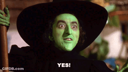 A Witch With Green Face Paint And A Black Hat Says " Yes " GIF
