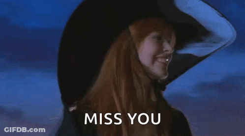 A Witch With Red Hair Is Wearing A Large Black Hat And Says Miss You . GIF