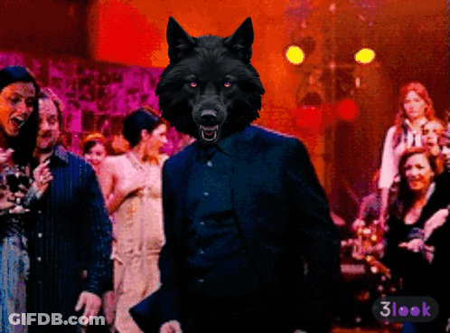 A Wolf In A Suit Stands In Front Of A Crowd Of People With A 3Look Sticker On The Bottom Right GIF