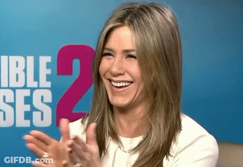 A Woman Applauds In Front Of A Sign That Says Ible Ses 2 GIF