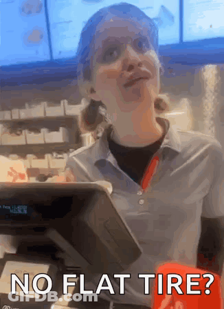 A Woman Behind A Counter With The Words No Flat Tire Below Her GIF