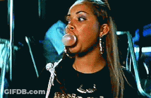 A Woman Blowing A Bubble With A Black Shirt That Says ' Snoop Dogg ' On It GIF