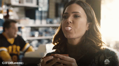 A Woman Blowing A Bubble With A Nbc Logo In The Foreground GIF