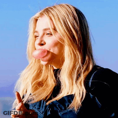 A Woman Blowing A Bubble With Her Tongue GIF