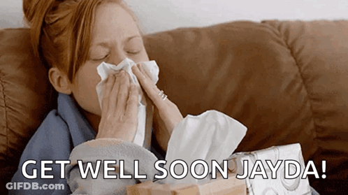 A Woman Blowing Her Nose While Sitting On A Couch With The Words Get Well Soon Jayda Written On The Bottom GIF