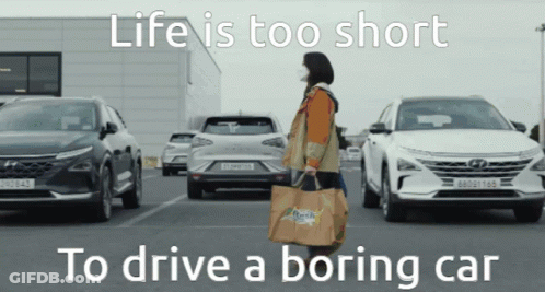 A Woman Carrying A Bag With The Words Life Is Too Short To Drive A Boring Car On It GIF