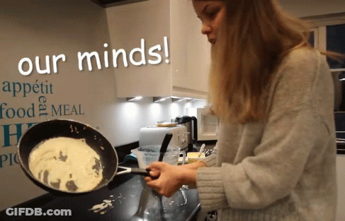 A Woman Cooking In Front Of A Wall That Says Our Minds On It GIF