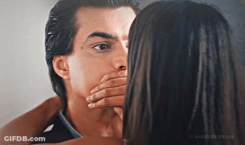 A Woman Covering A Man 'S Mouth With Her Hand And The Word Punch Is On The Bottom Right GIF