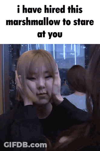 A Woman Covering Her Ears With Her Hands And A Caption That Says I Have Hired This Marshmallow To Stare At You GIF
