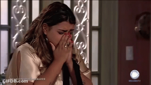 A Woman Covering Her Face While Watching A Recordtv Show GIF