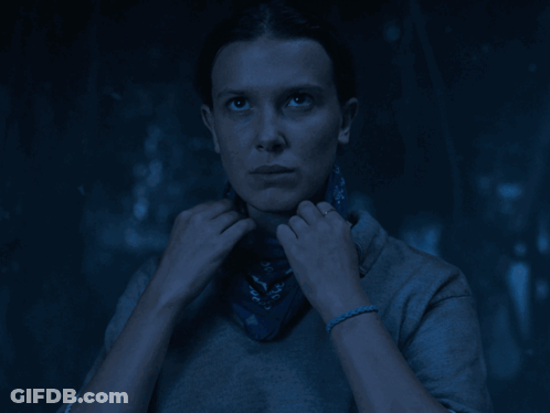 A Woman Covering Her Face With A Blue Bandana With Letters A And D On It GIF